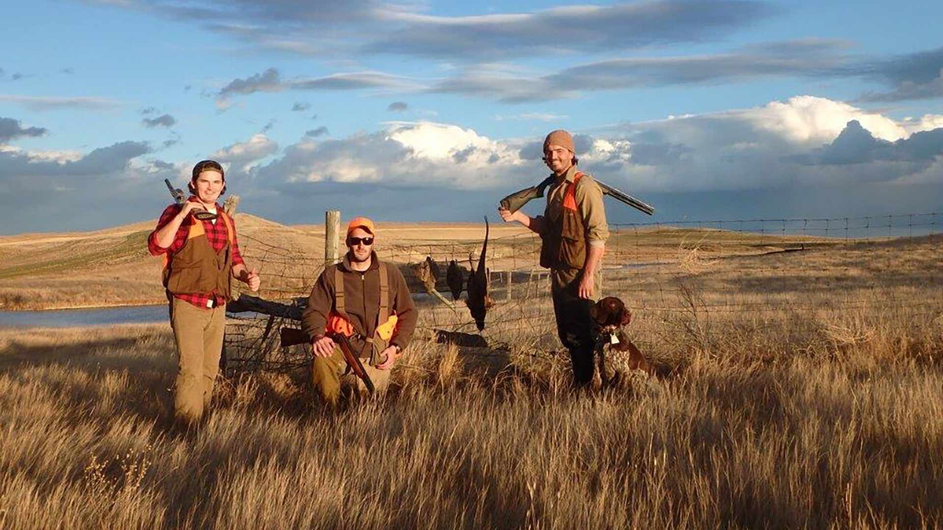 Three hunters with guns and dog in Montana