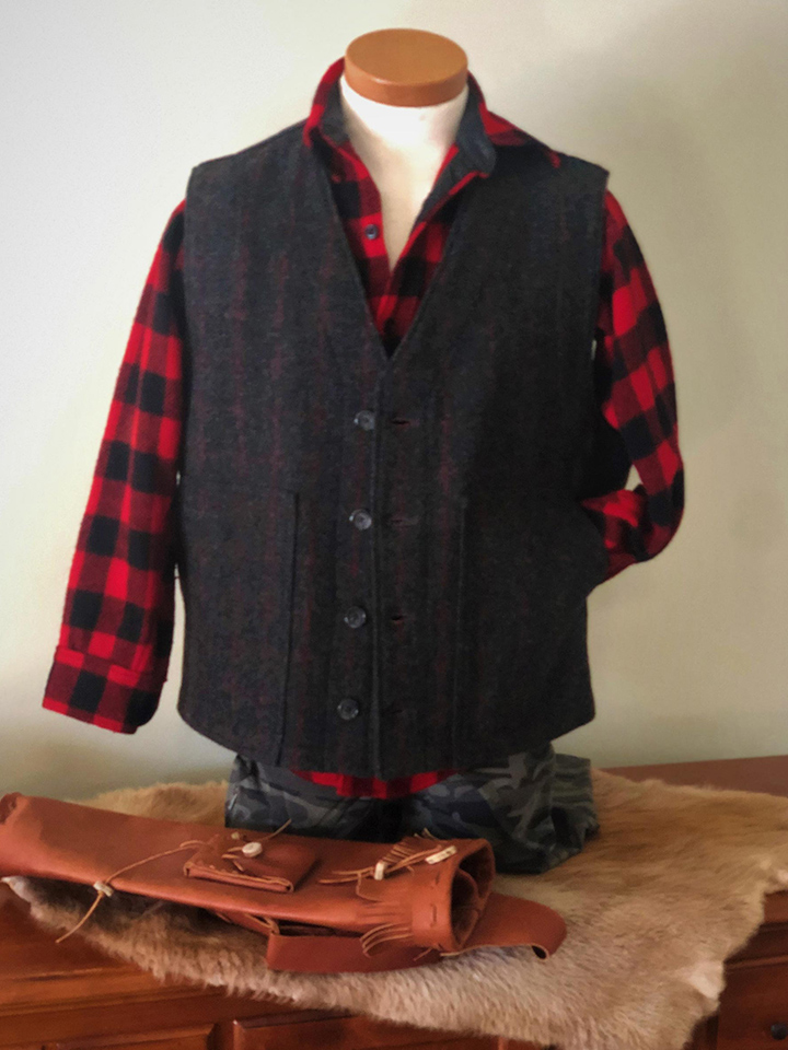 Button up layering vest on mannequin torso with bow quiver in front